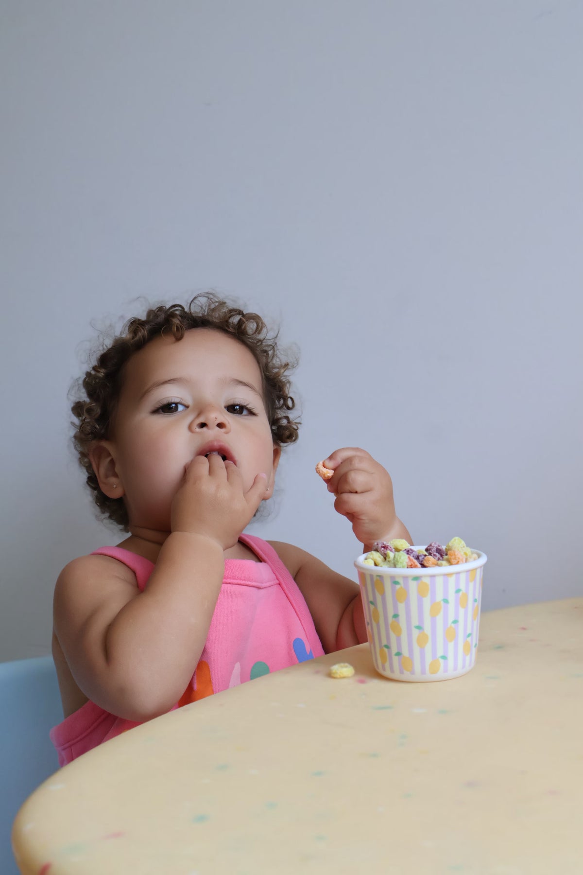 Child enjoying snacks from a BBcino snack pot